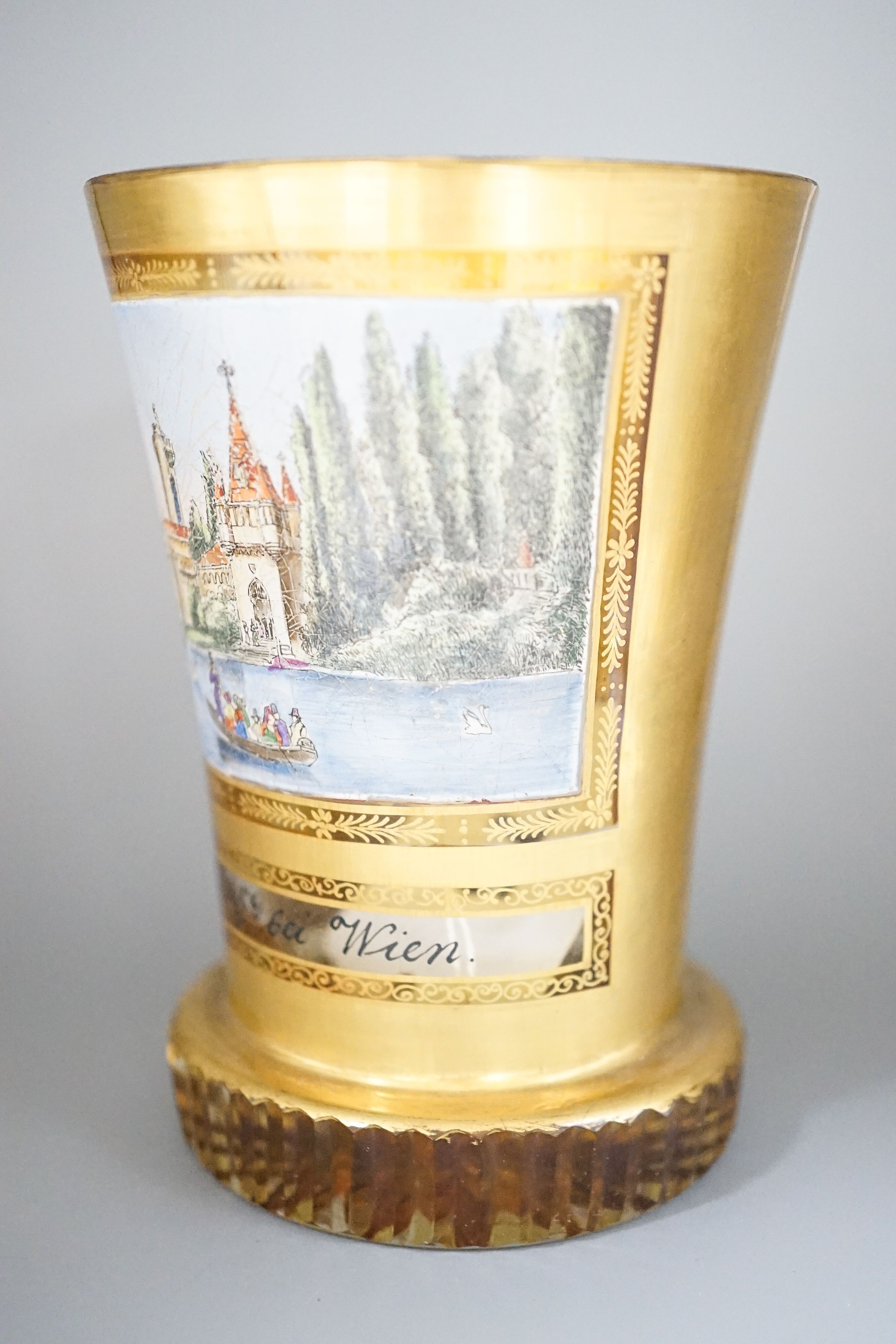 A 19th century Bohemian enamelled and gilded glass beaker 11cm, with titled scene Layenburg bei Wien